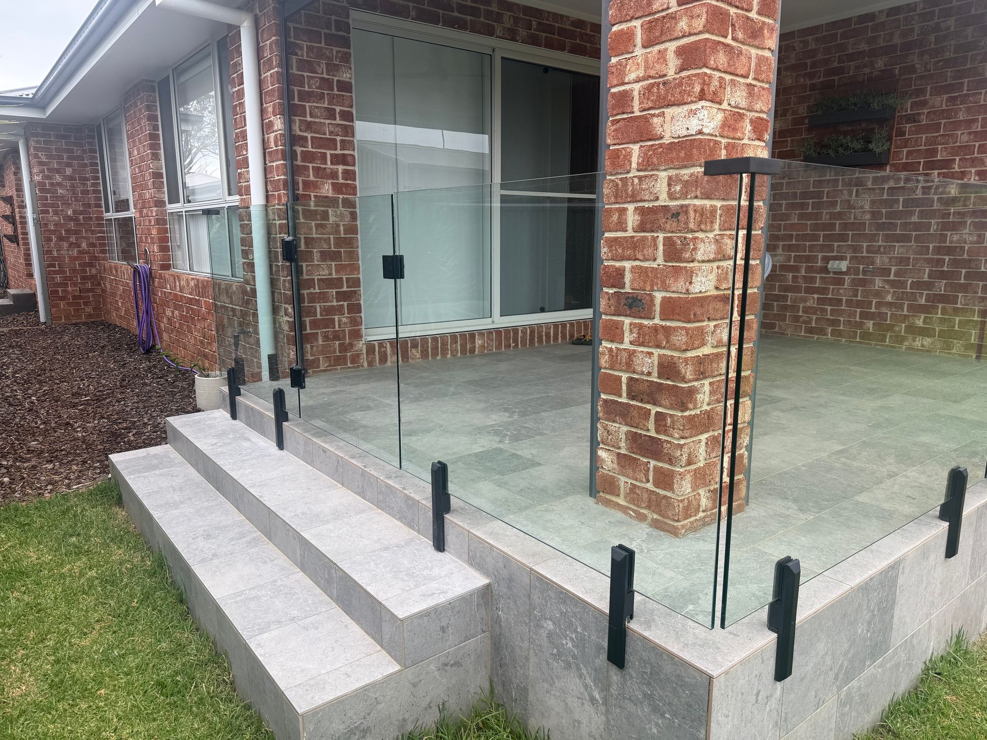 Balustrade Glass window surrounding brick house patio - Canobolas Glass Service In Orange, NSW