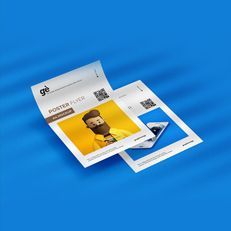 A couple of flyers sitting on top of each other on a blue surface.