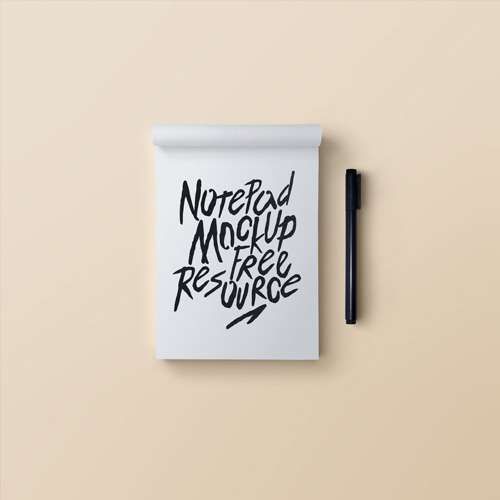 A notepad mockup with a pen on a beige background.