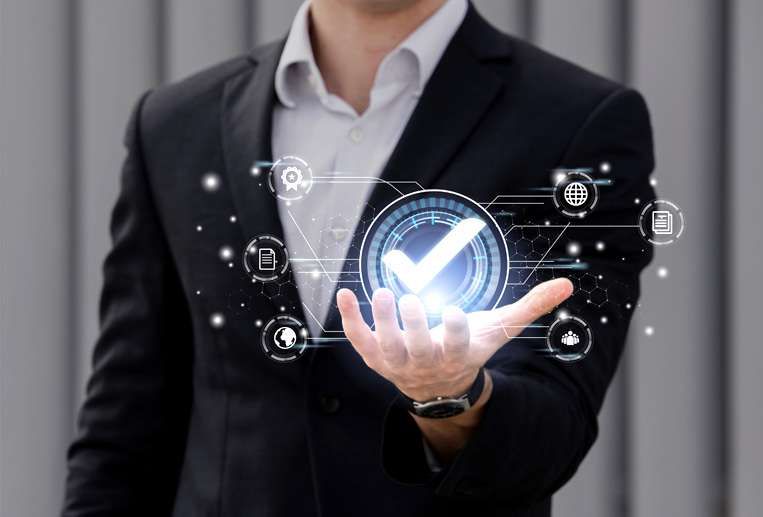 A man in a suit is holding a check mark in his hand.