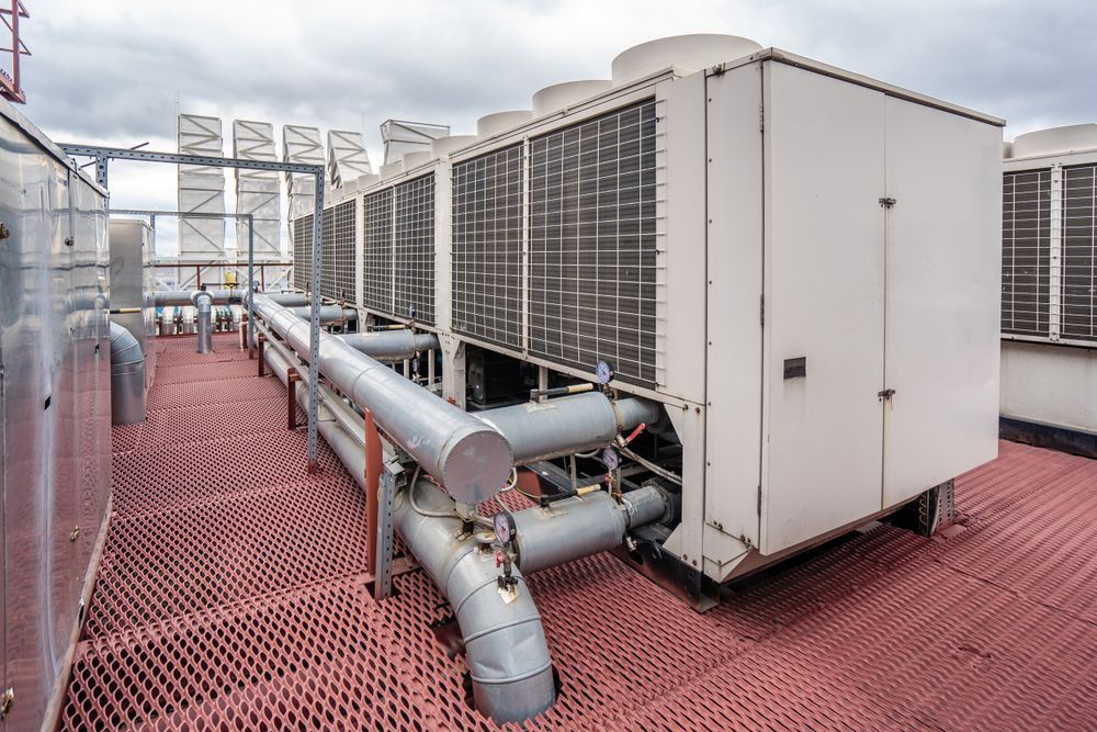 Rooftop Air Conditioning Units with Metal Grates and Pipes — MAE Refrigeration In Gordonvale, QLD