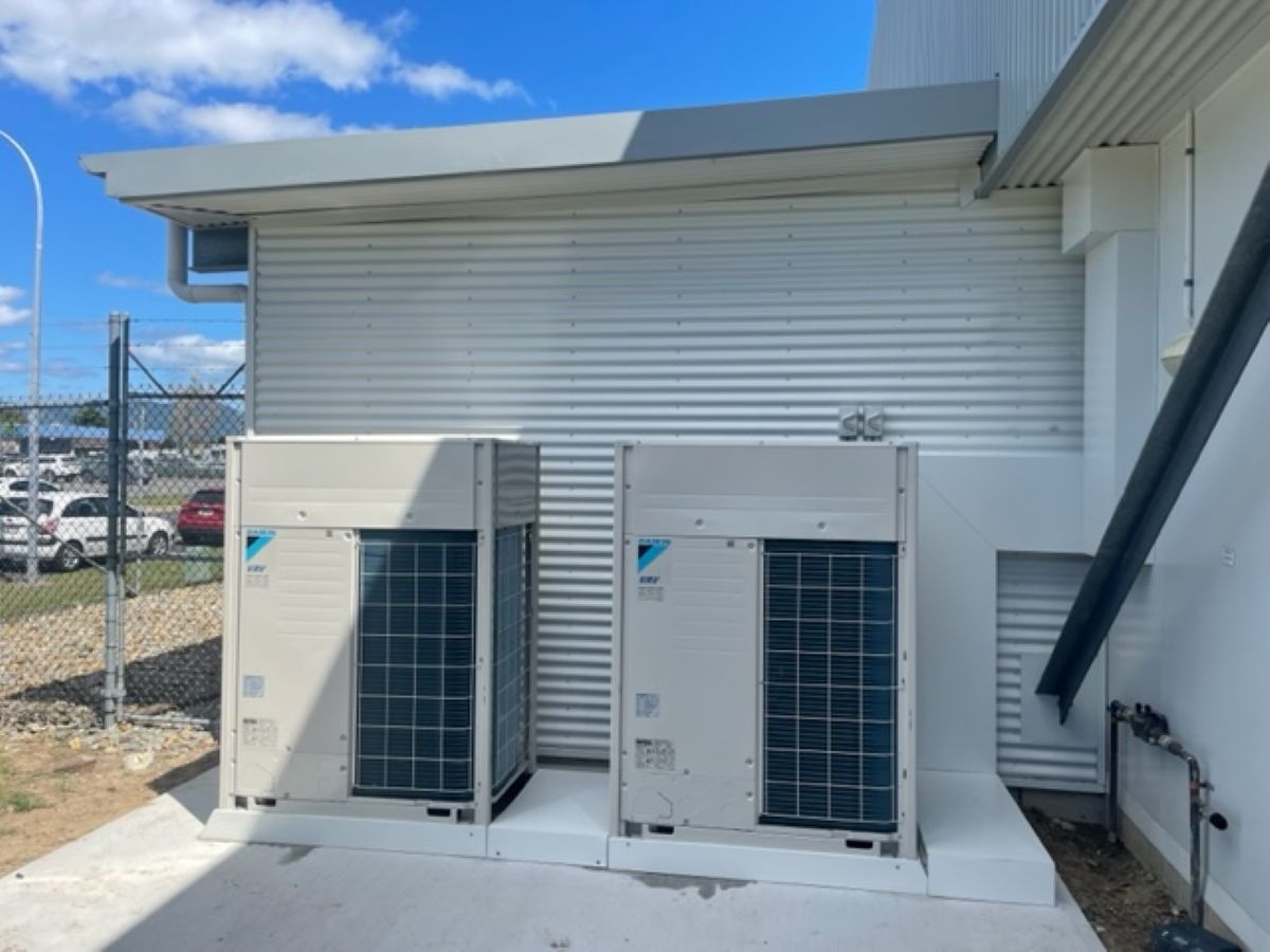 Two Daikin Hvac Units Outside a Building with Metal Siding — MAE Refrigeration In Mission Beach, QLD