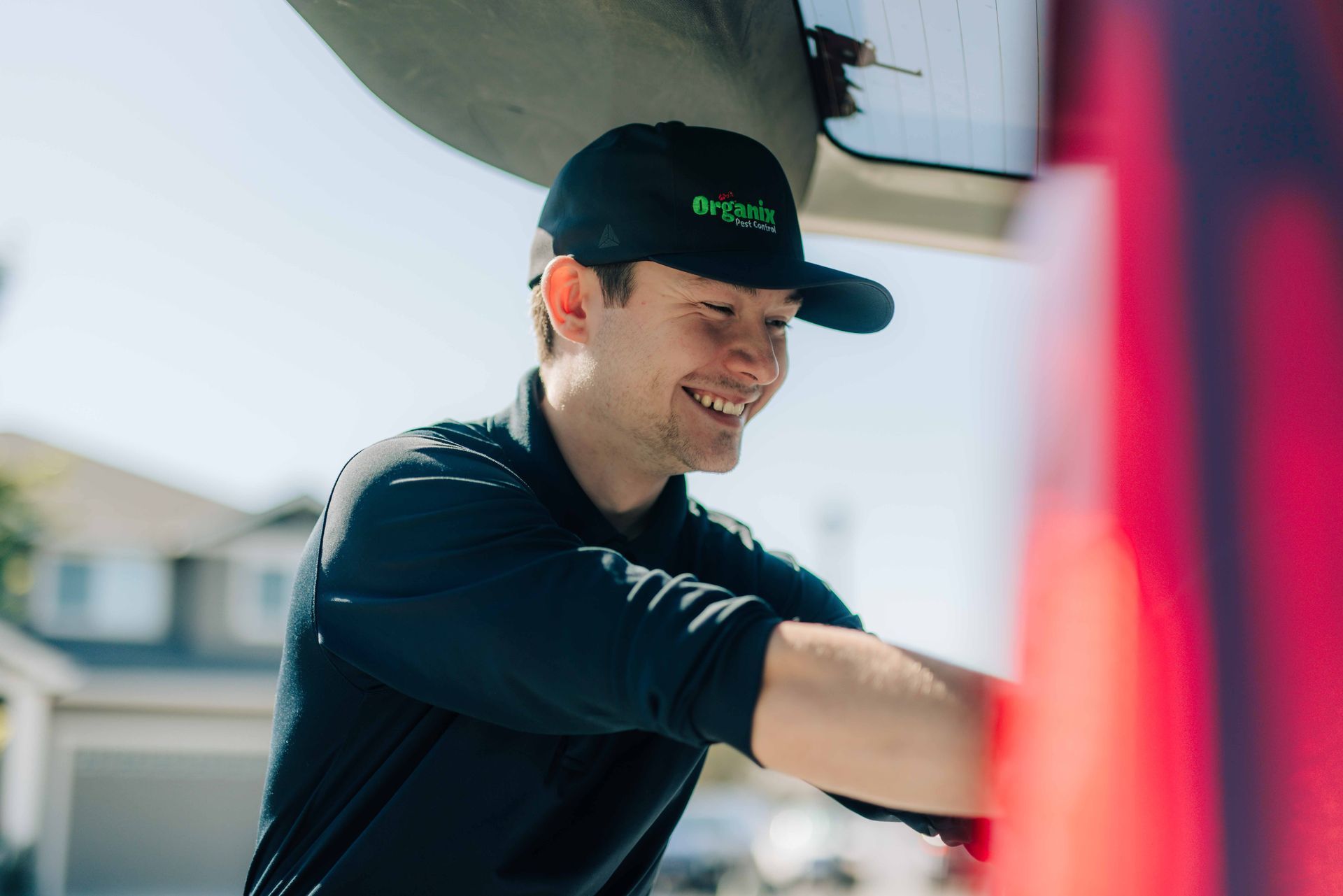 An image of a pest control technician smiling.