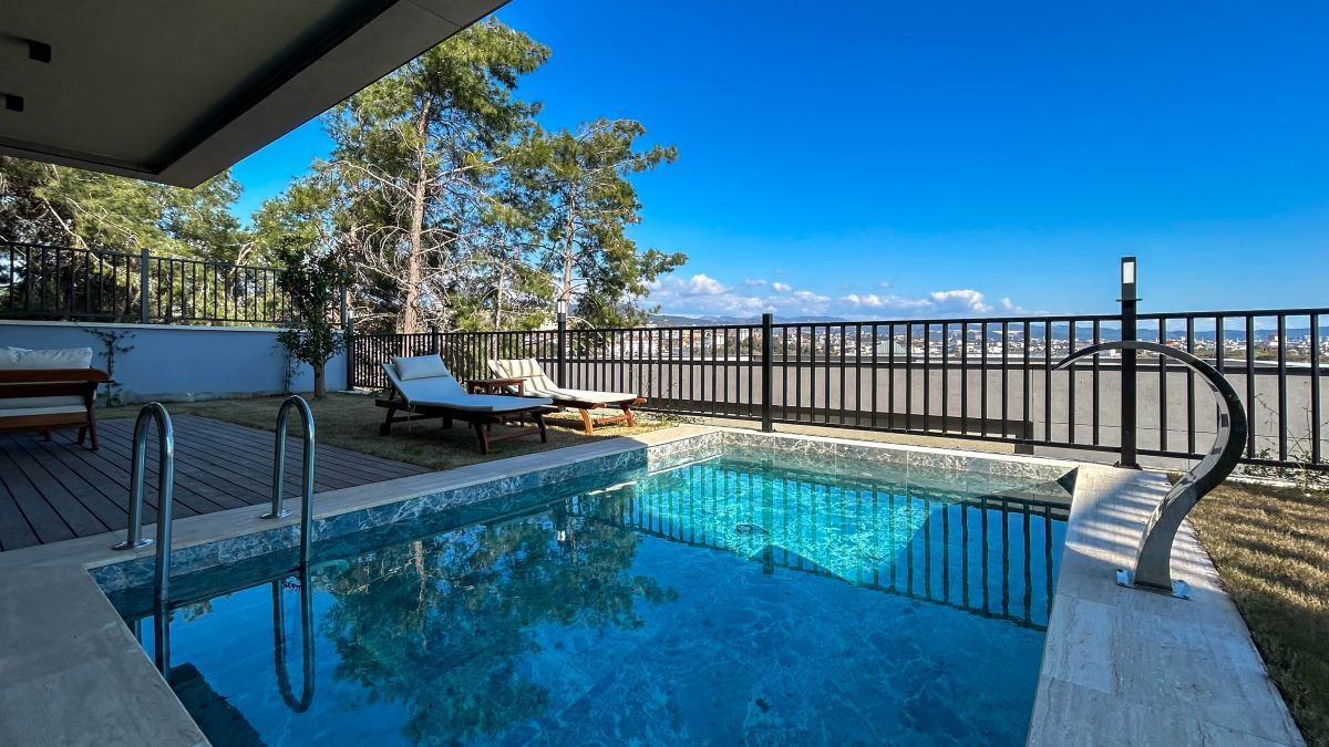 There is a Large Swimming Pool in the Backyard of a House — Aztech Fencing In Laurieton, NSW