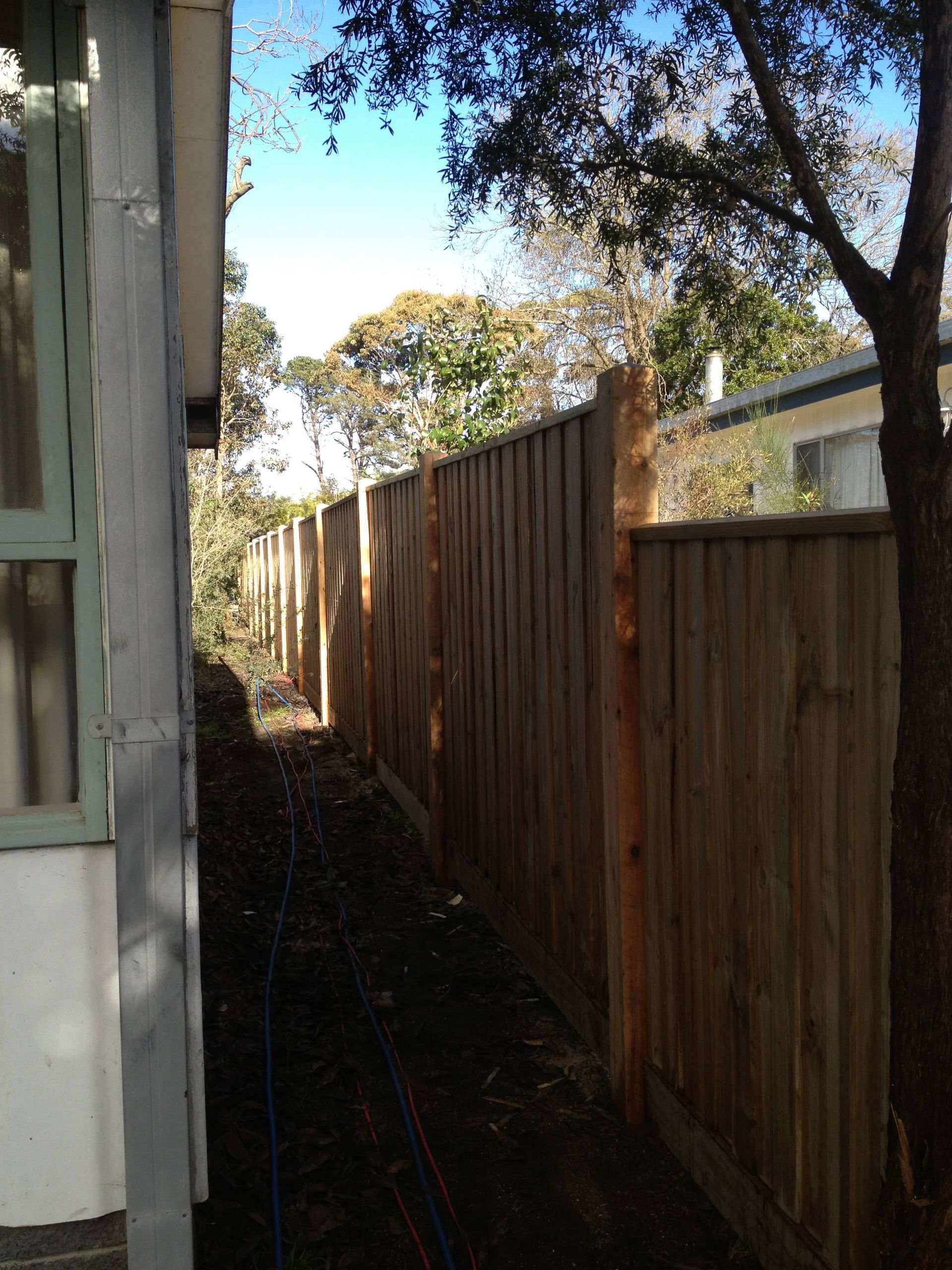A wooden fence along the side of a house — Aztech Fencing In Upsalls Creek, NSW