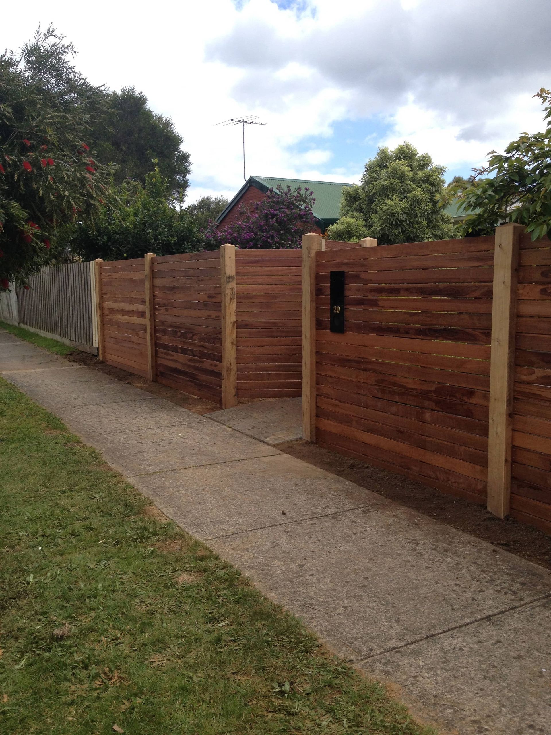 A wooden fence along a sidewalk next to a house — Aztech Fencing In Upsalls Creek, NSW
