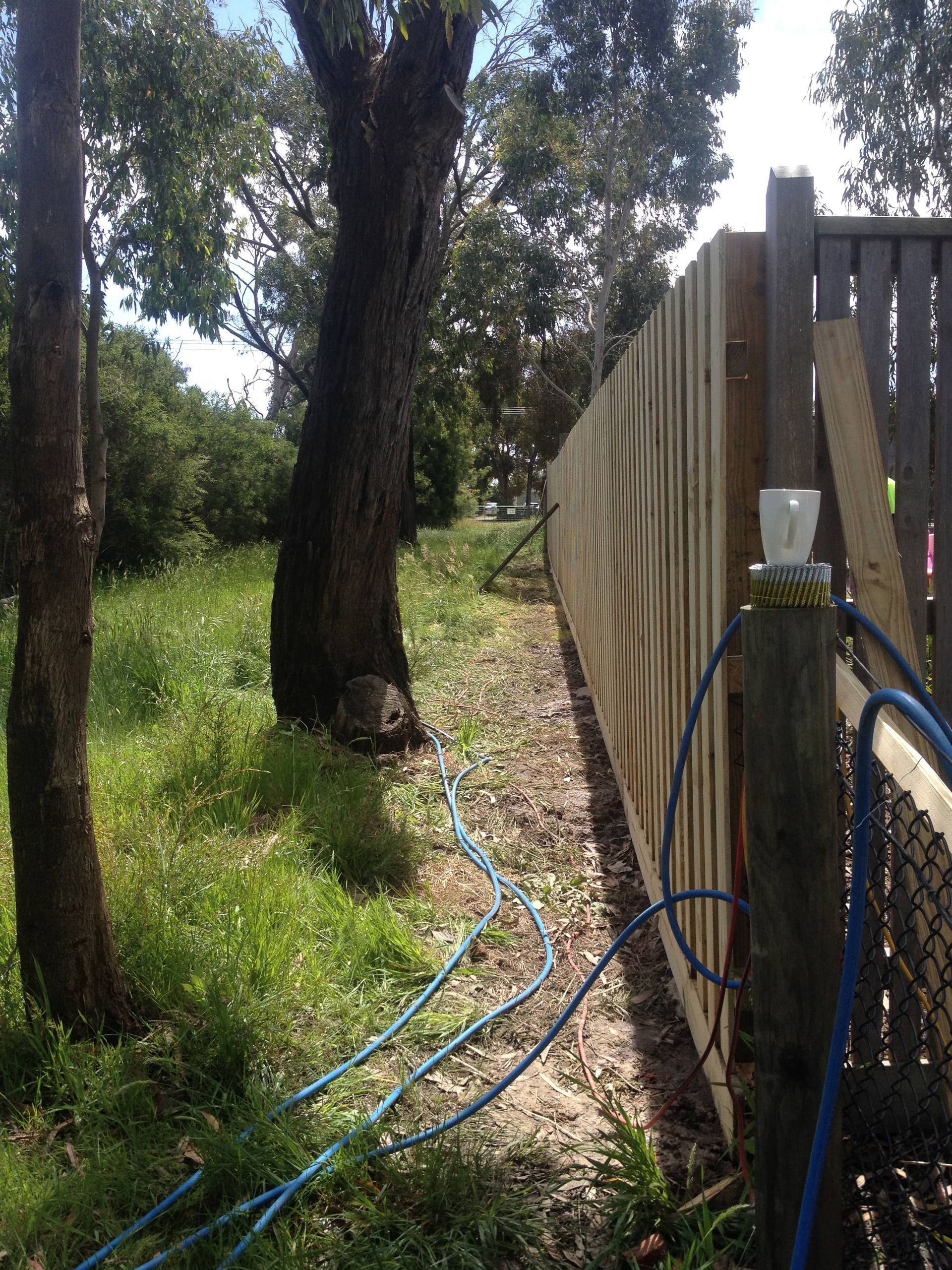 A wooden fence with a hose attached to it — Aztech Fencing In Upsalls Creek, NSW