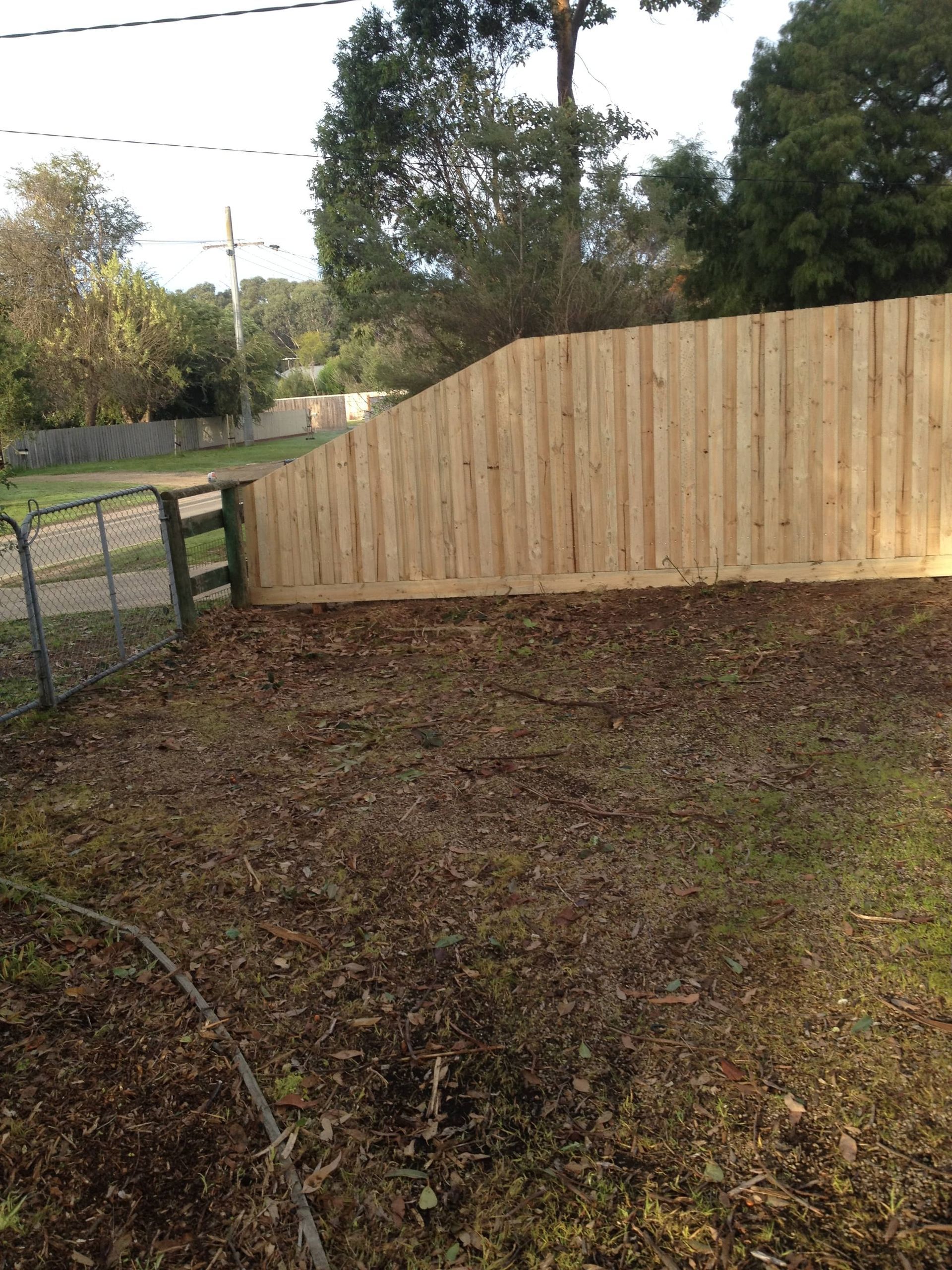 A wooden fence is in the middle of a yard — Aztech Fencing In Upsalls Creek, NSW