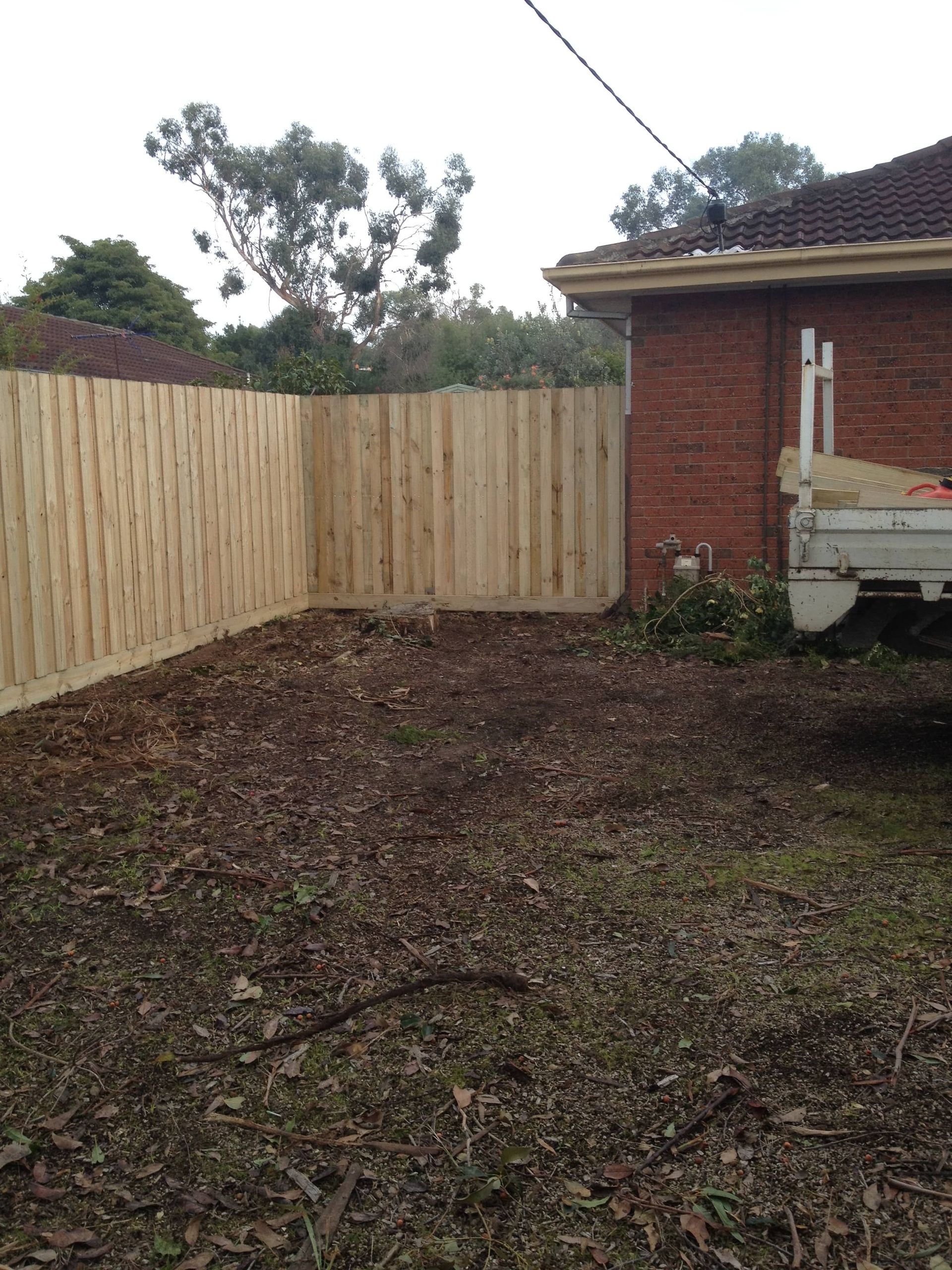 A white truck is parked in front of a wooden fence — Aztech Fencing In Upsalls Creek, NSW