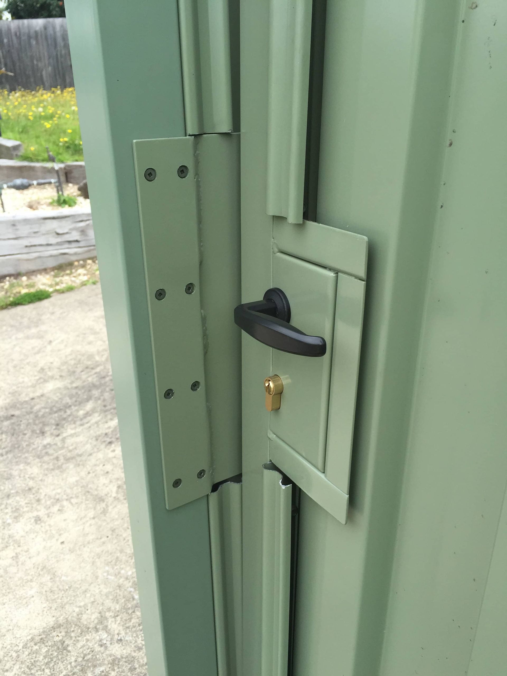 A green door with a black handle and a key on it — Aztech Fencing In Upsalls Creek, NSW