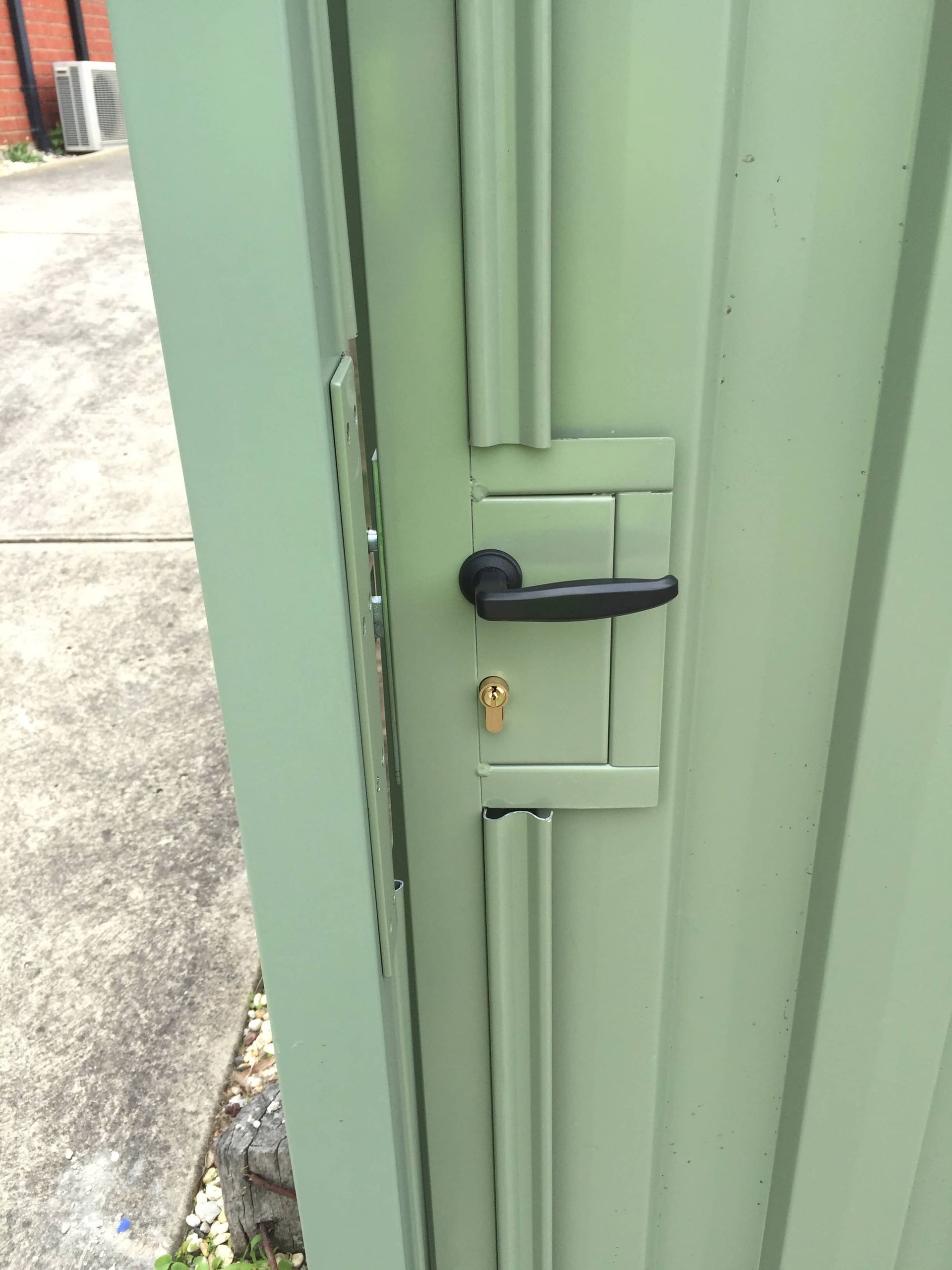 A green door with a black handle and a key on it — Aztech Fencing In Upsalls Creek, NSW