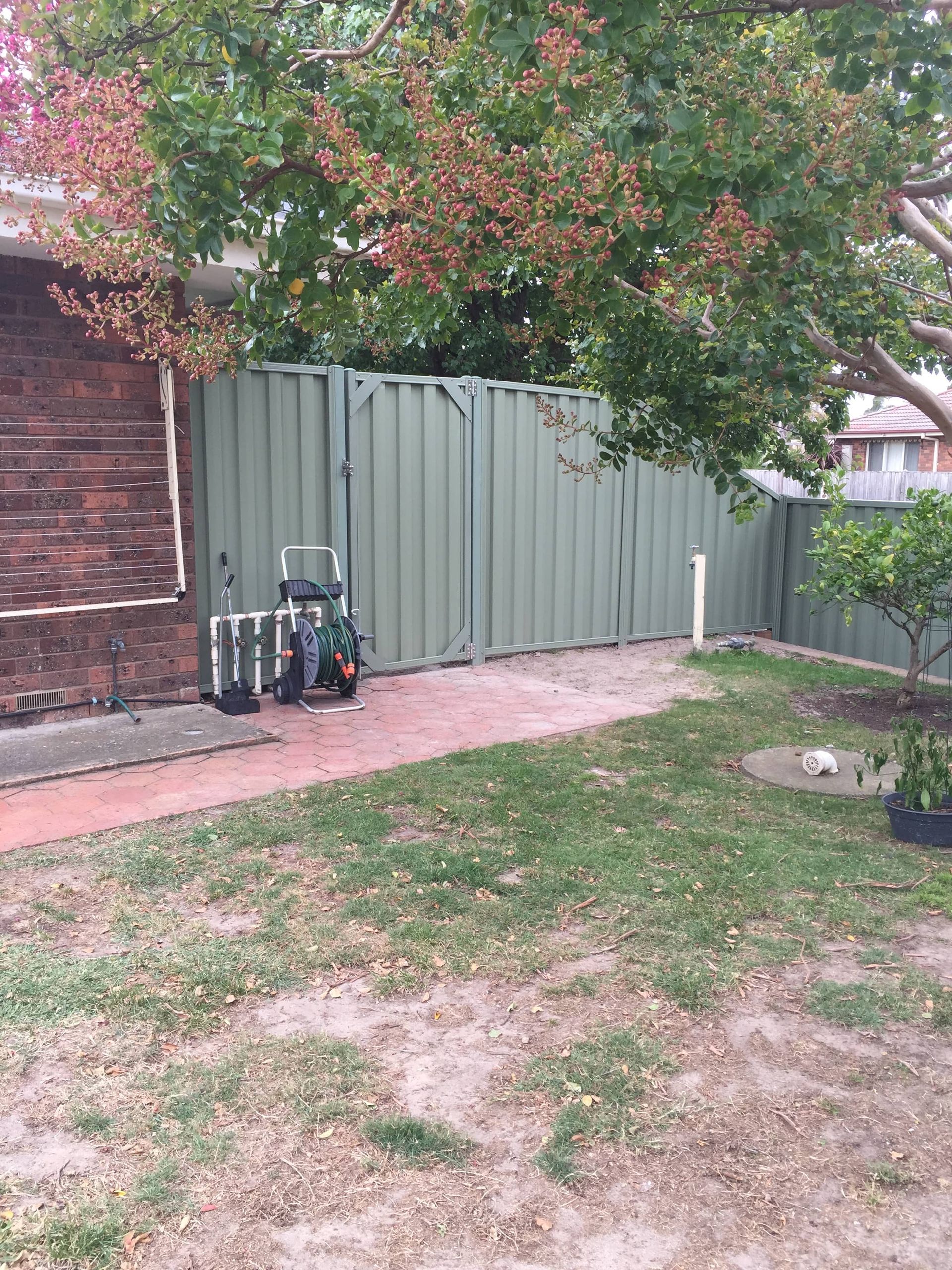 There is a green fence in the backyard of a house — Aztech Fencing In Upsalls Creek, NSW