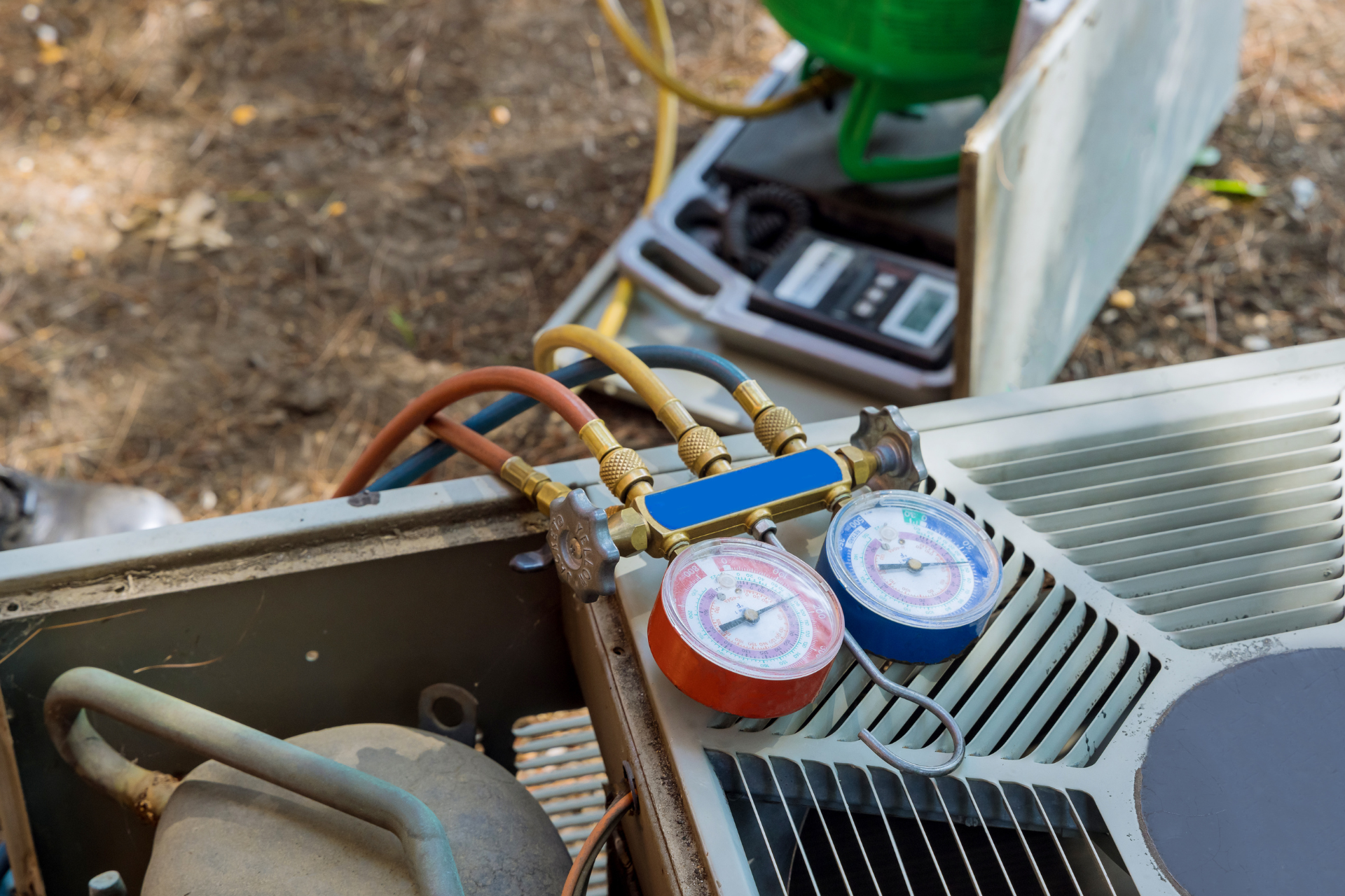 A close up of a refrigerator with two gauges attached to it.