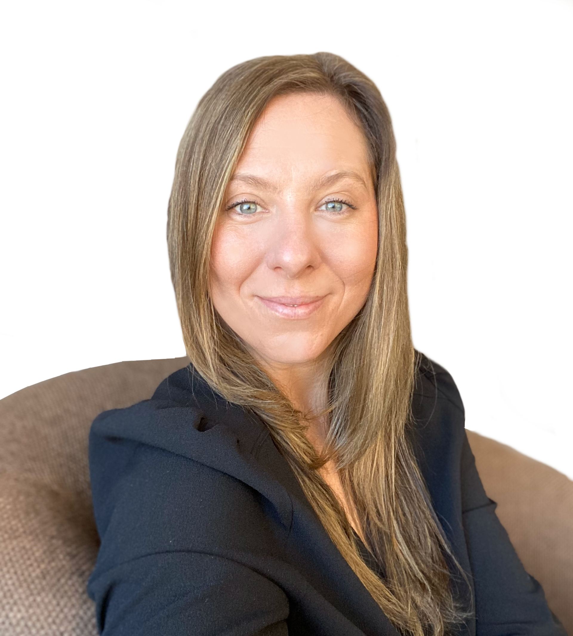 A woman is sitting in a chair and smiling for the camera.