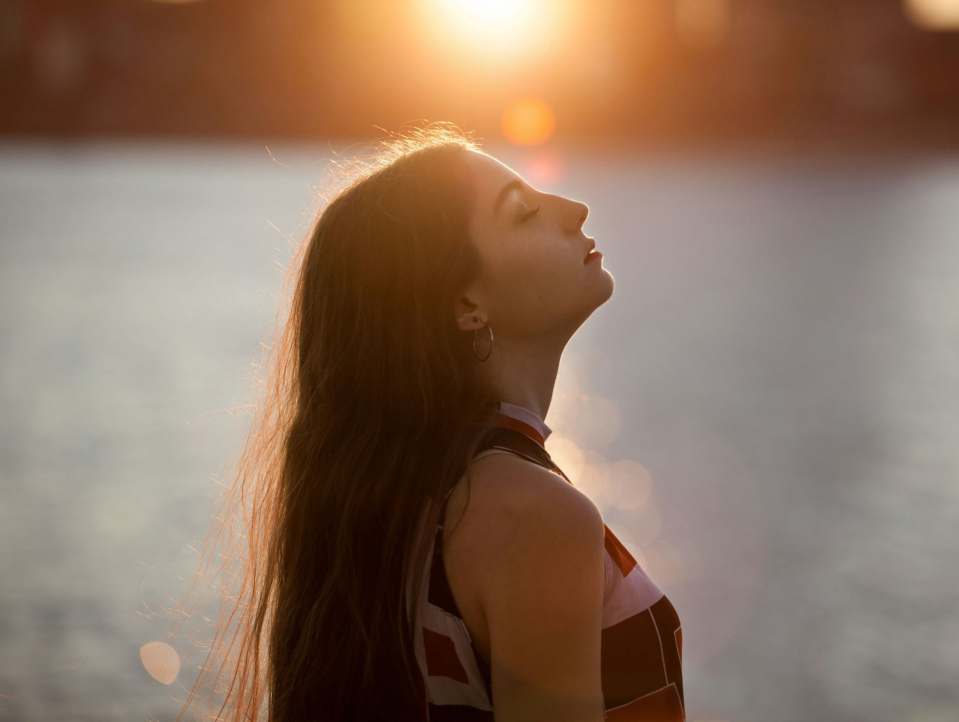 Tired woman beside Kempenfelt Bay wonders if she is experiencing burnout or depression
