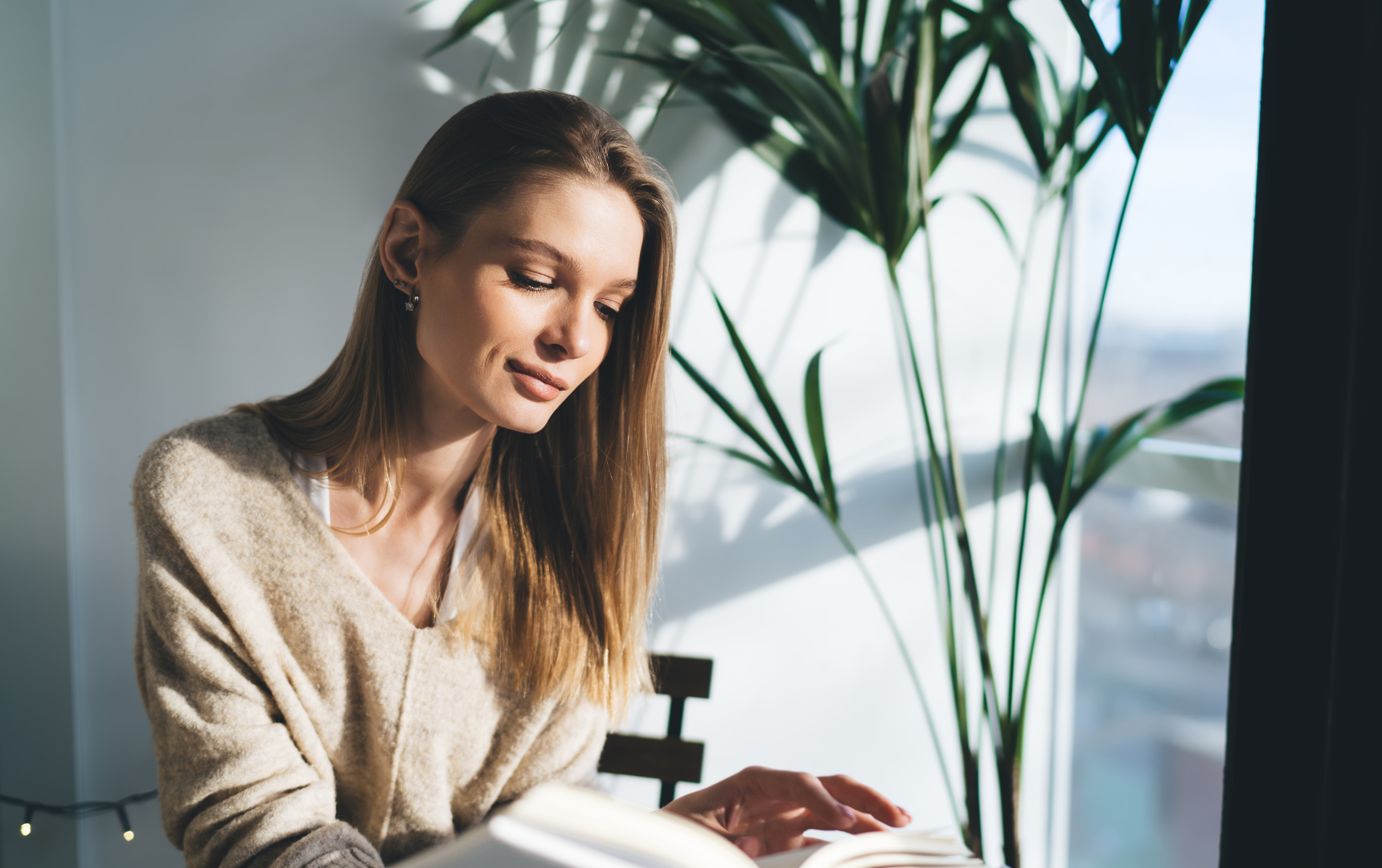 A woman is smiling and crying in a black and white photo.