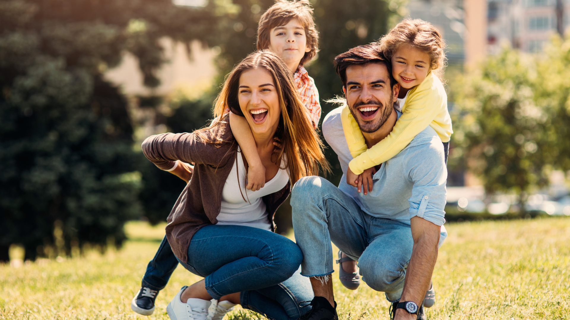 A family is posing for a picture in a park.