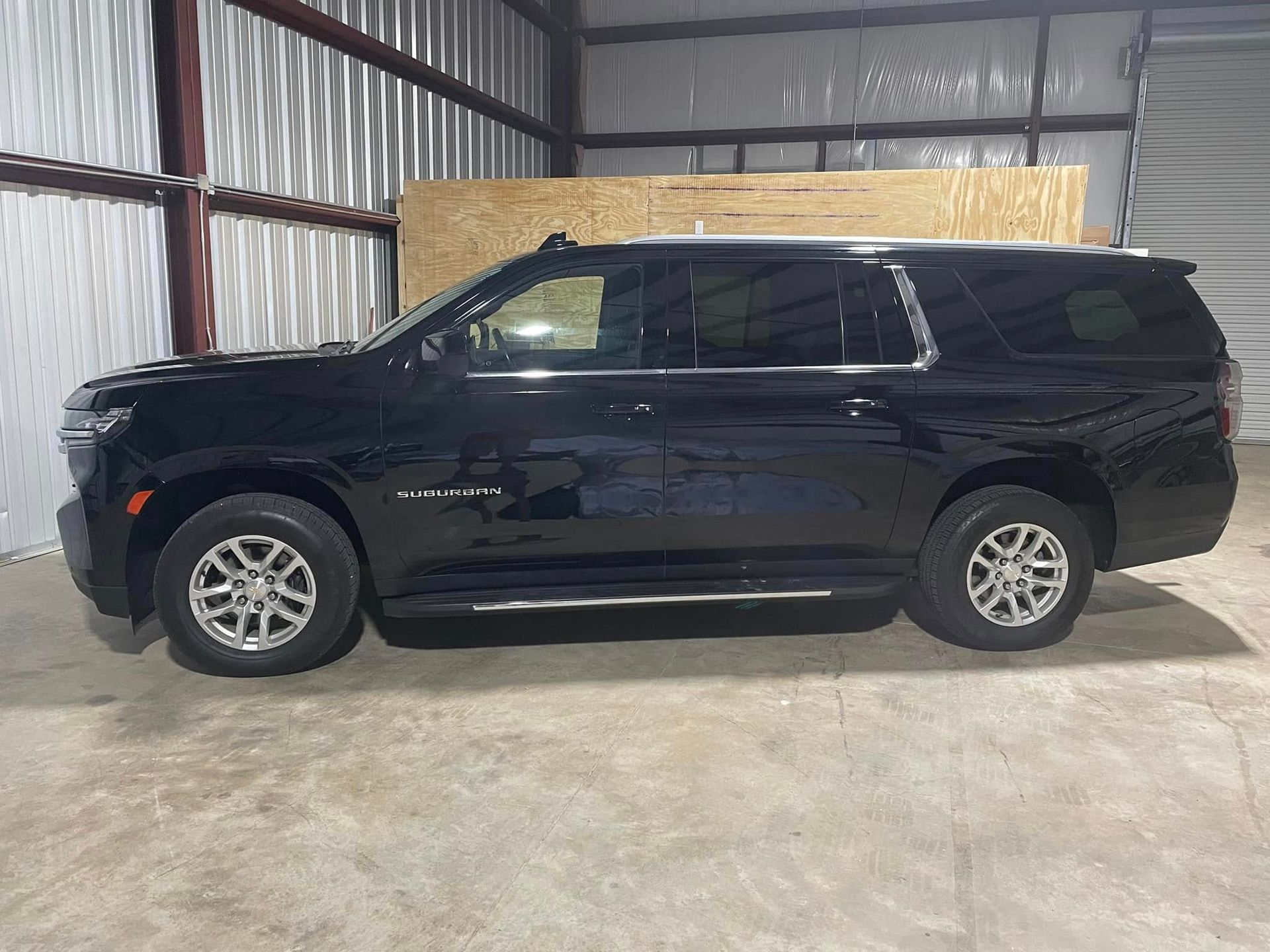 A black suv is parked in a garage.