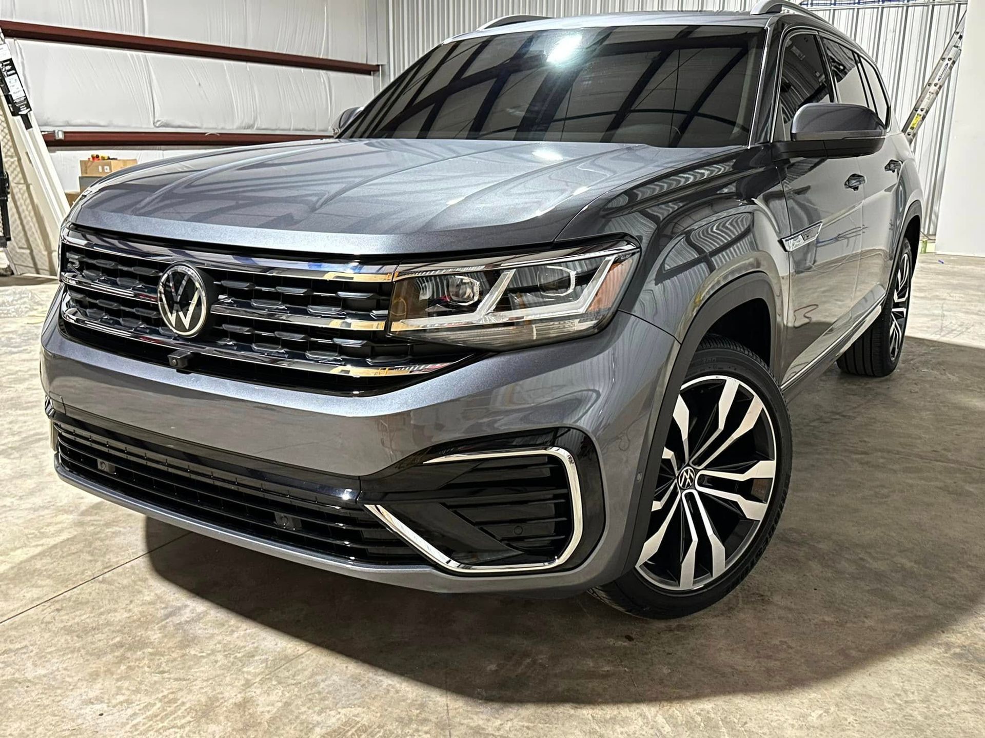 A volkswagen atlas is parked in a garage.