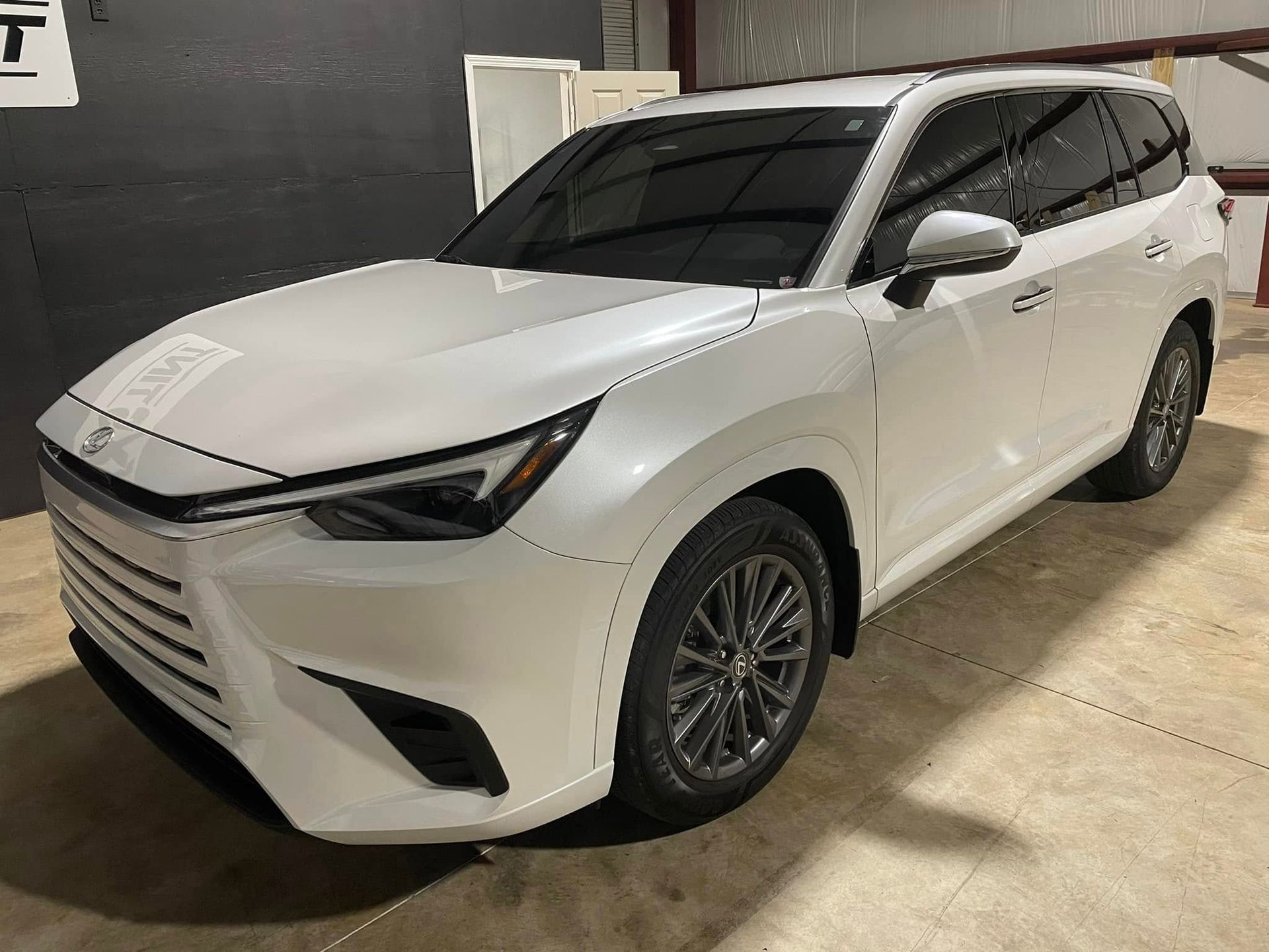 A white suv is parked in a garage.