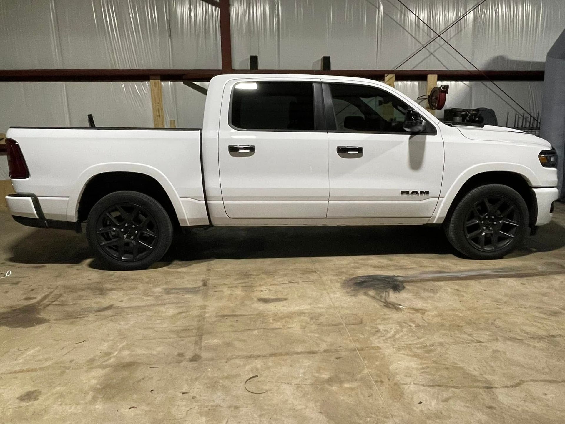 A white ram 1500 truck is parked in a garage.