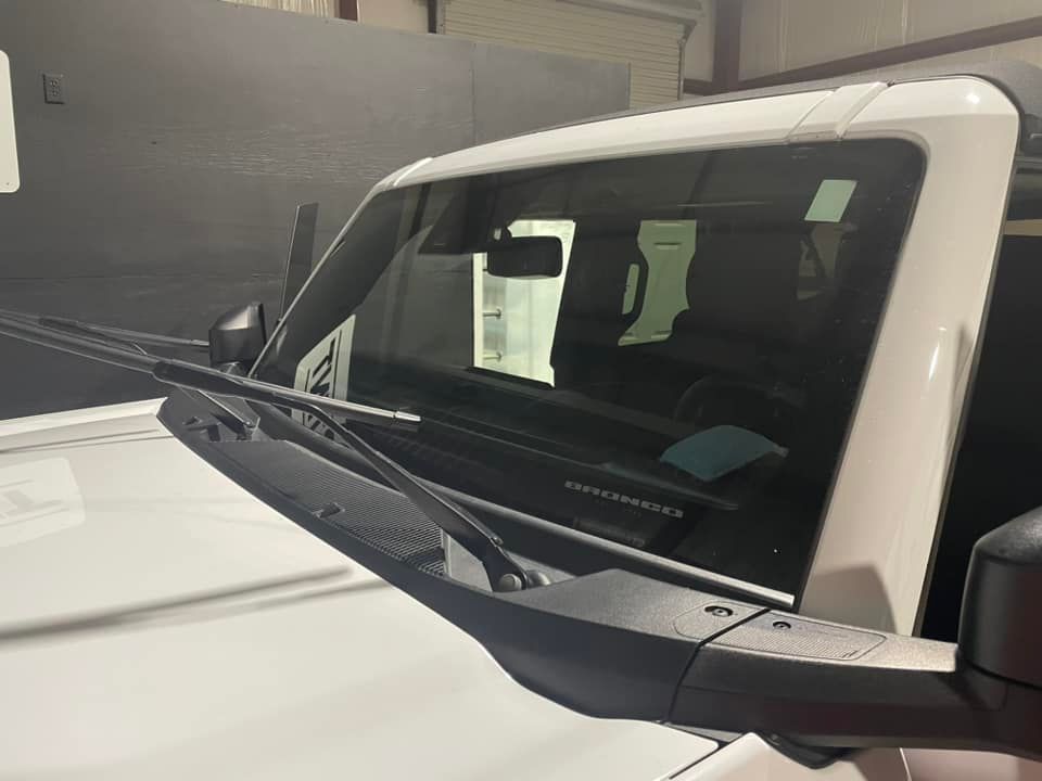 A white truck with a wiper on the windshield