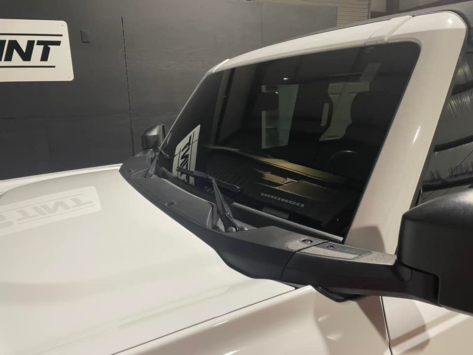 A white truck is parked in front of a sign that says int