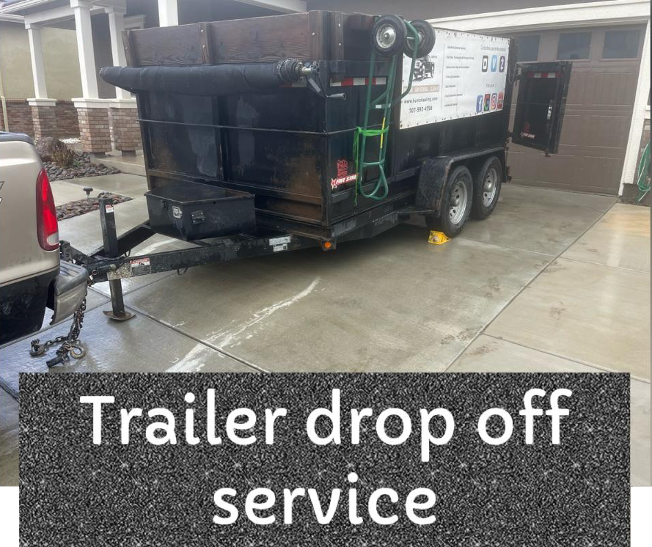 A trailer is parked in a driveway next to a truck.