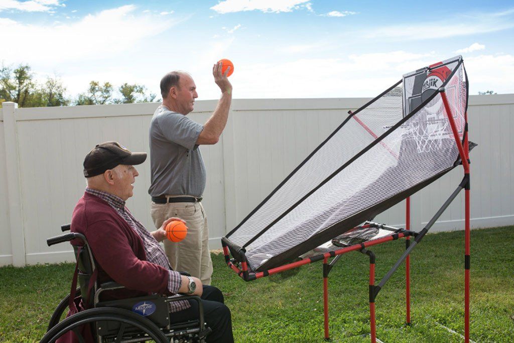 A man in a wheelchair is playing a game with another man.