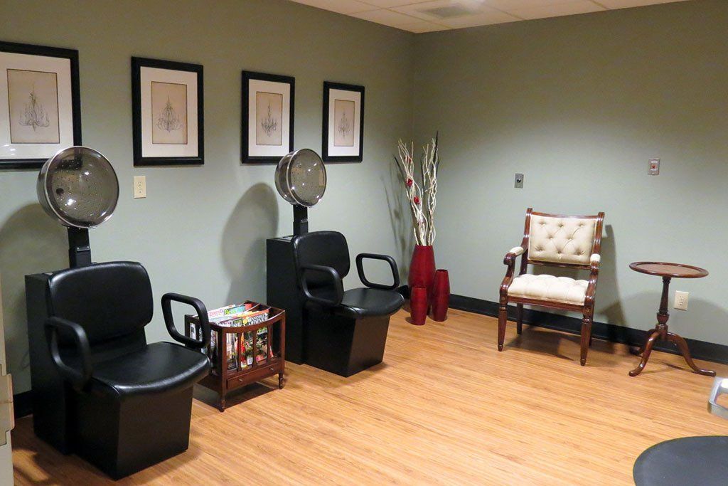 A room with chairs and hair dryers in it