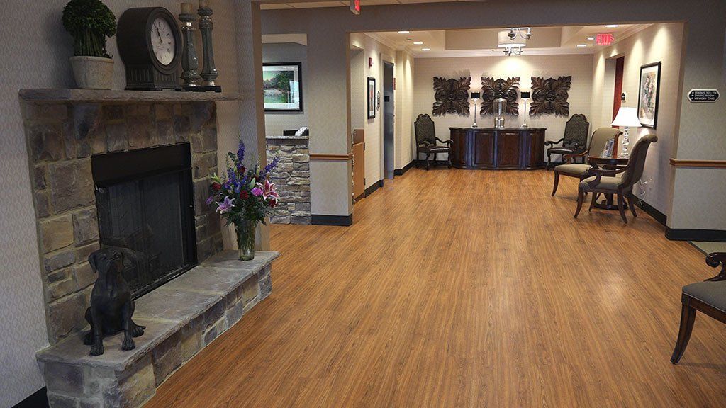 A living room with a fireplace and a clock on the wall