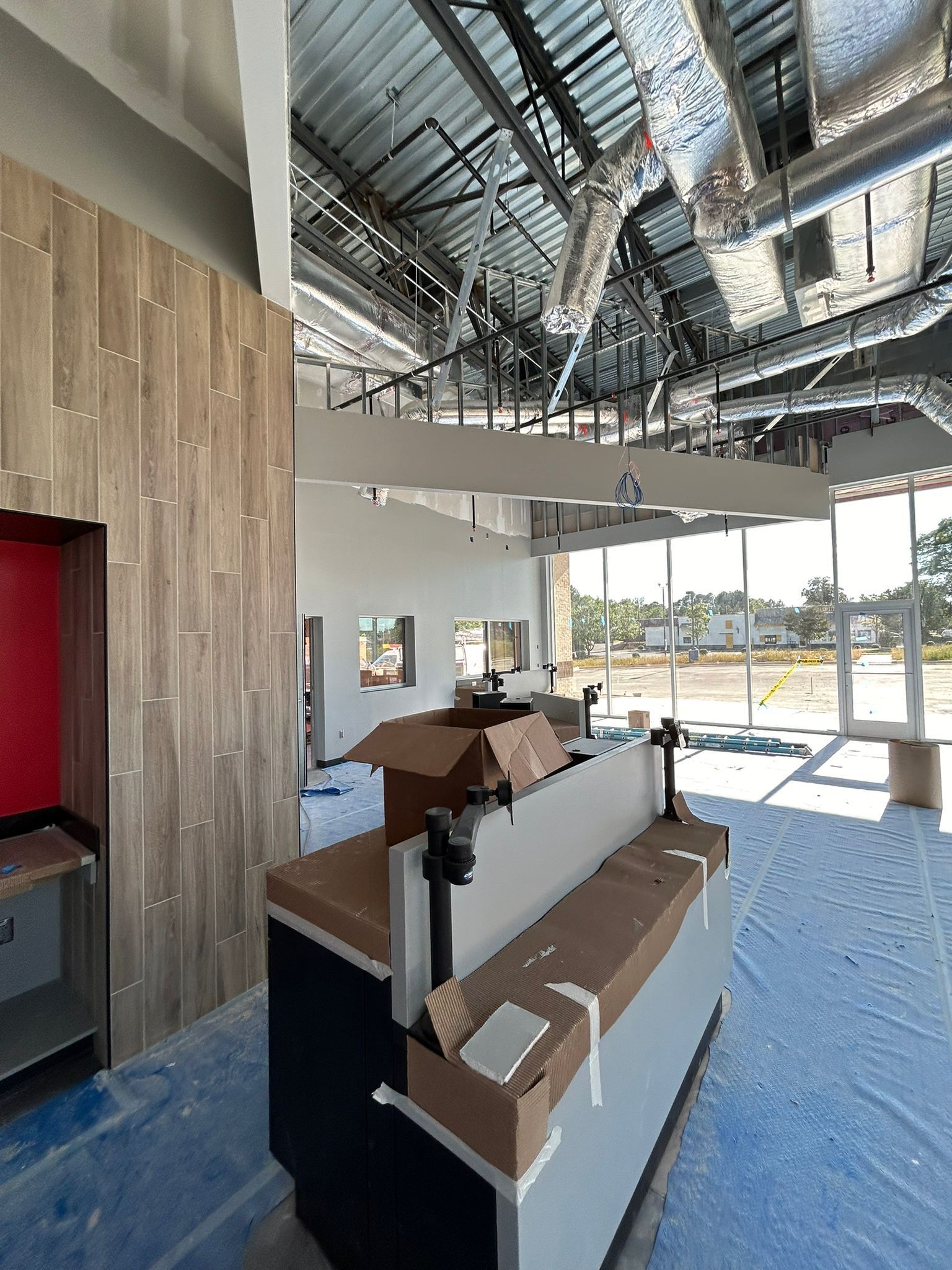A large room with a lot of windows and boxes on the floor.
