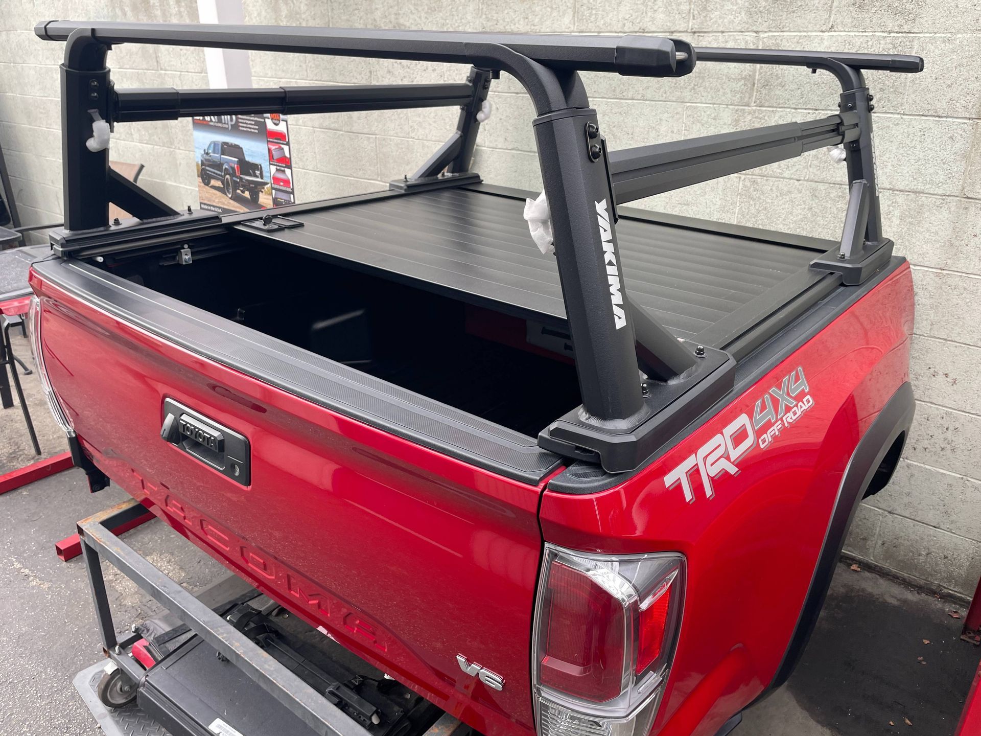 A red truck with a roof rack on top of it.
