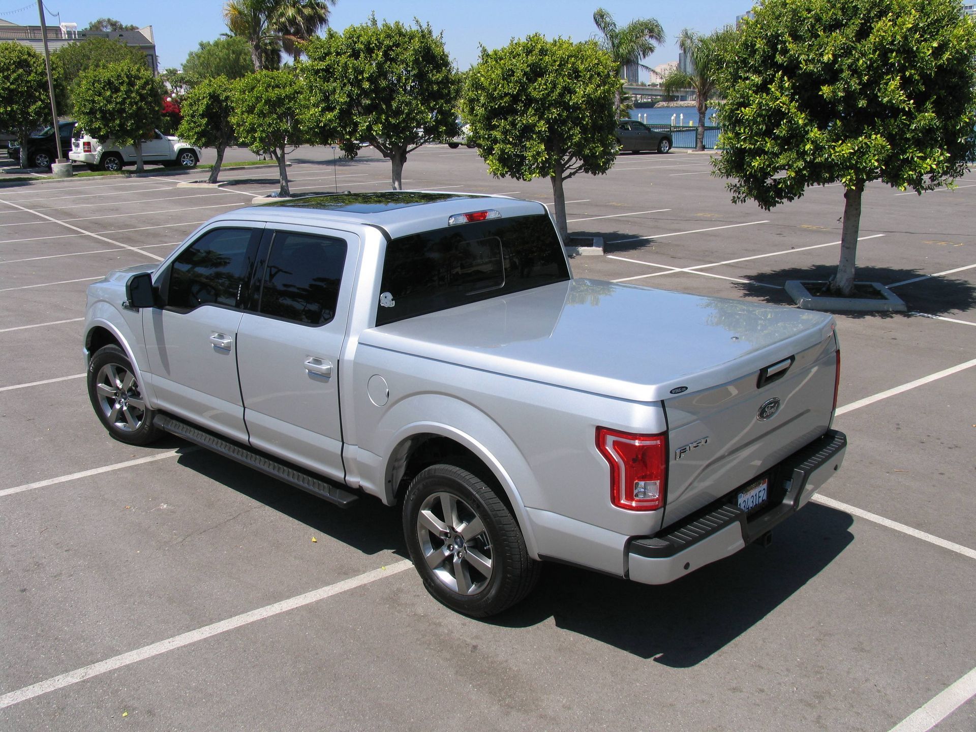 A silver truck is parked in a parking lot