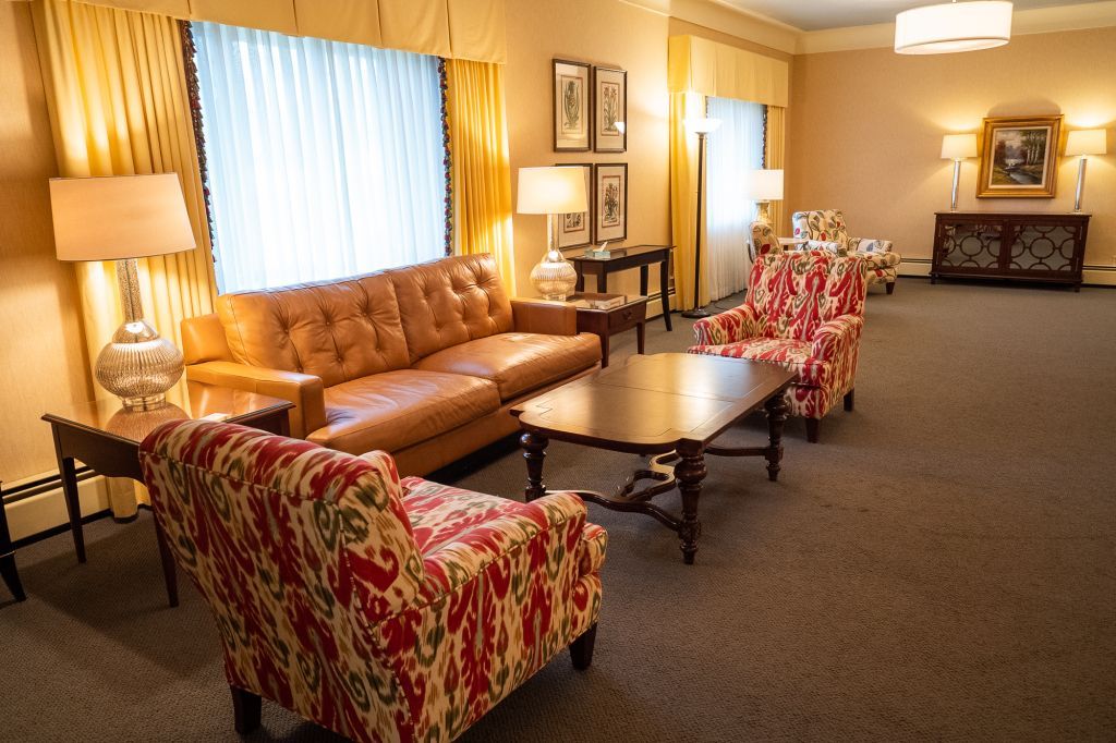 a living room with a couch , chairs , and a coffee table .