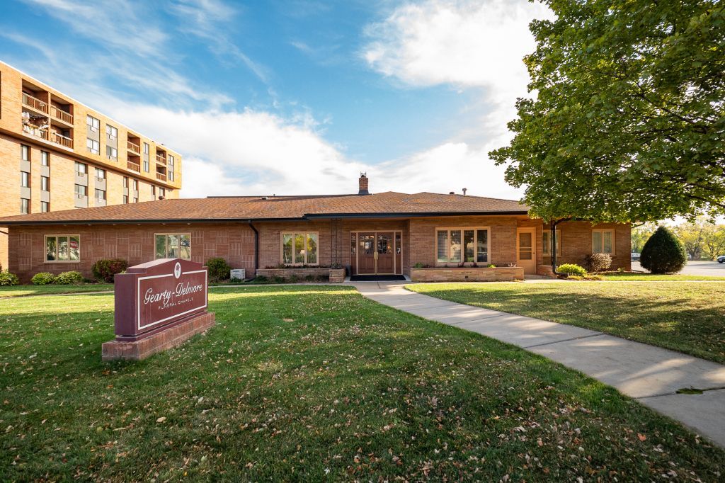 a large brick building with a sign in front of it .