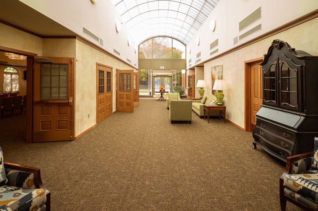 a long hallway with a lot of furniture in it .