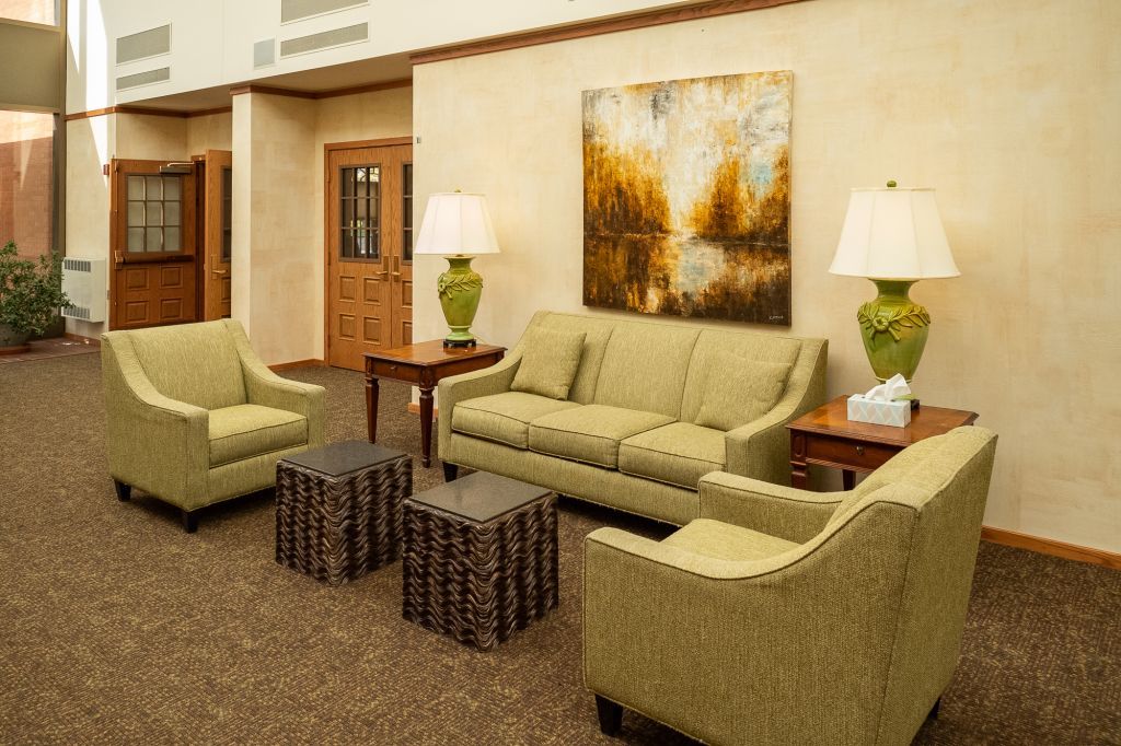 a living room with a couch , chairs , tables and lamps