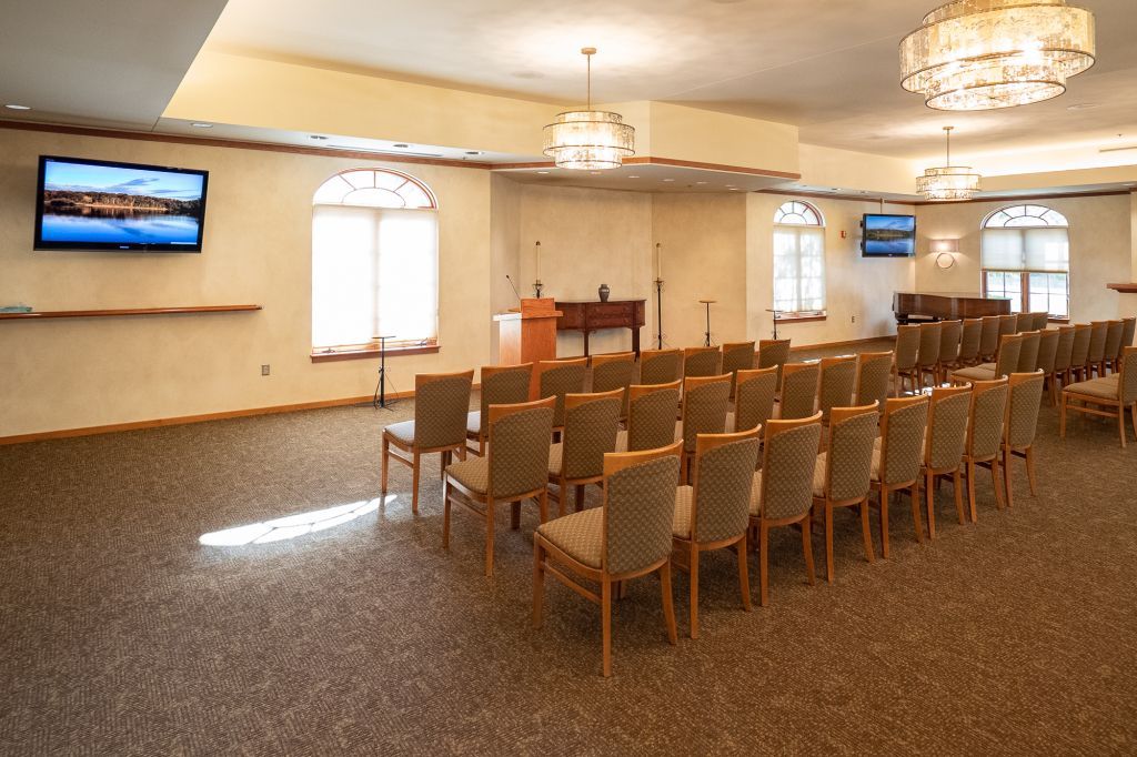a large room with rows of chairs and a podium