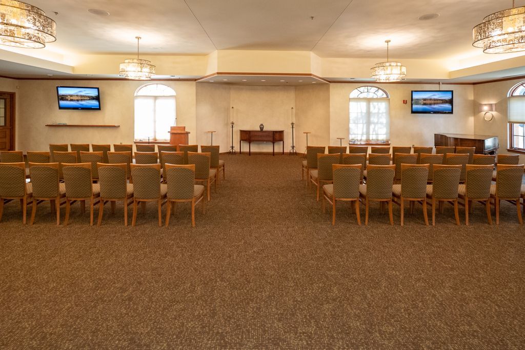a large room with rows of chairs and a podium