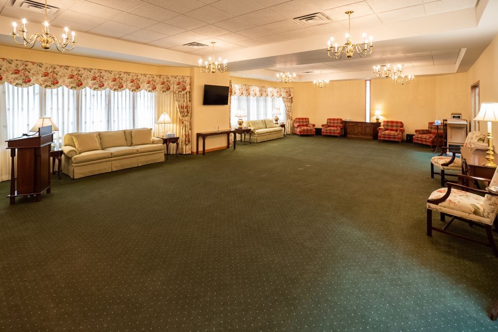 a large room with green carpet and a lot of furniture
