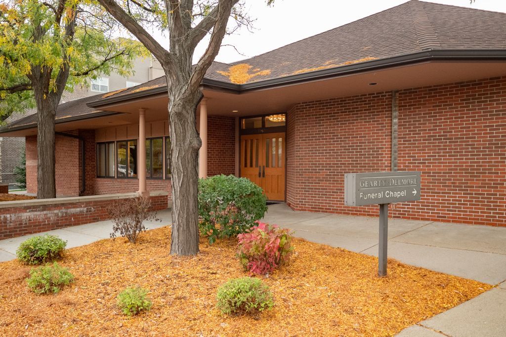 a brick building with a sign in front of it