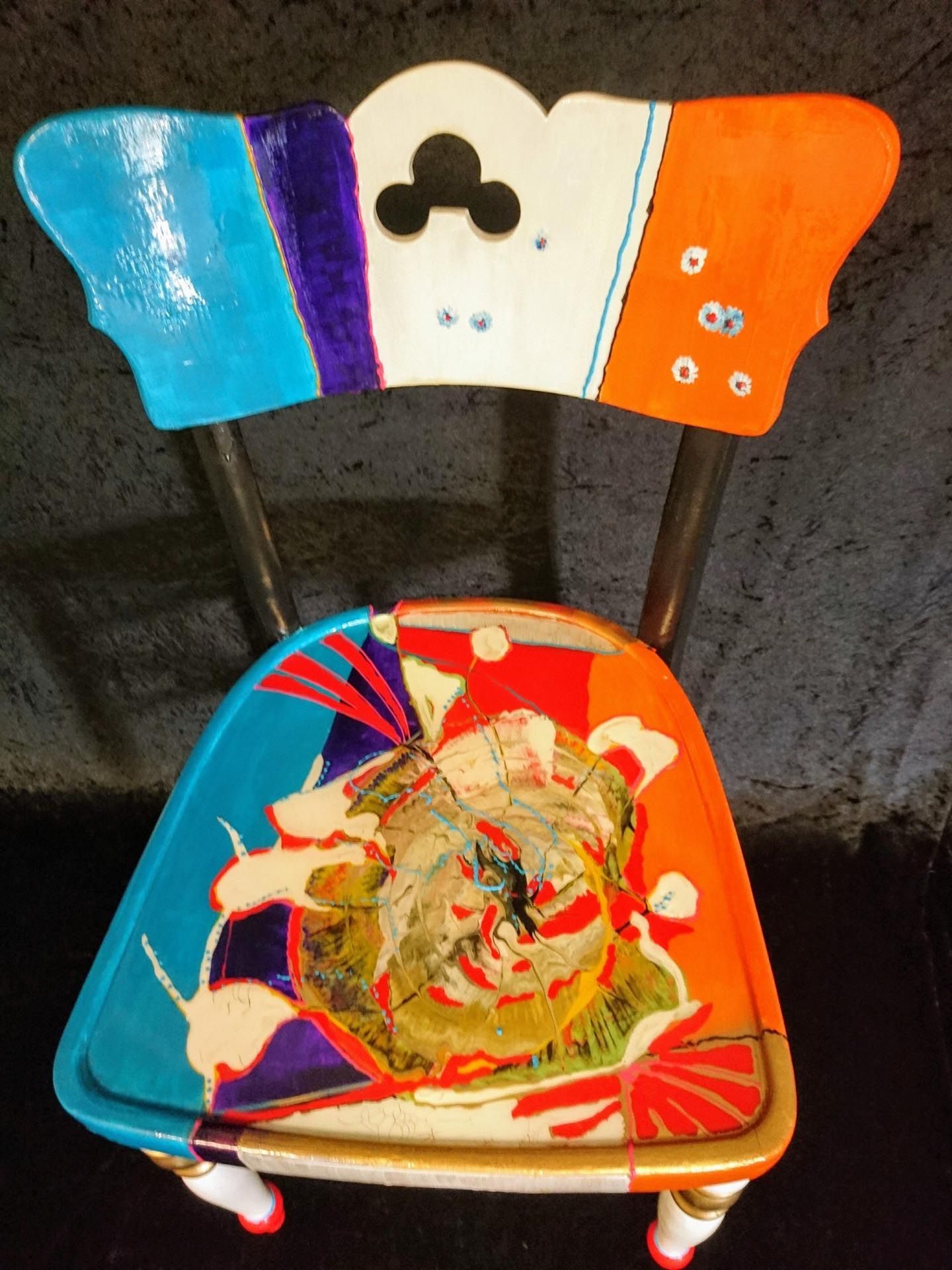 Ein bunter Stuhl mit einer Mickey Maus auf der Rückenlehne