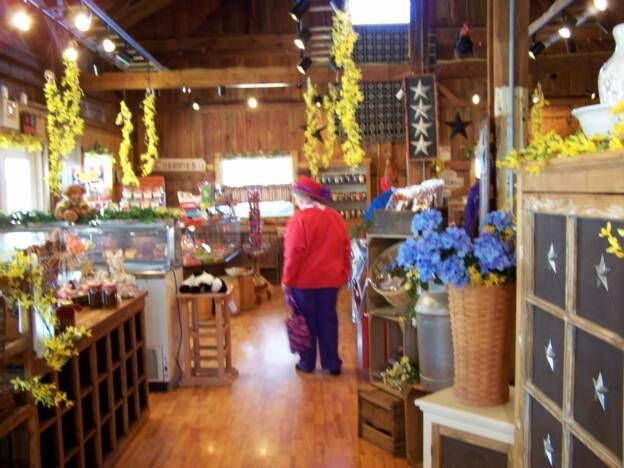 A woman in a red jacket is walking through a store