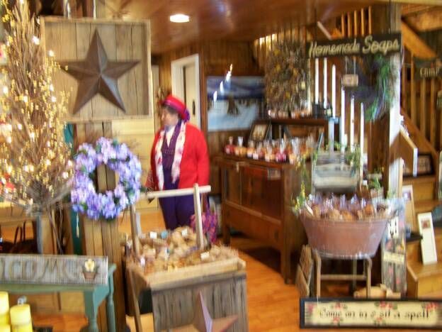 A woman is standing in a room with a sign that says homemade soups