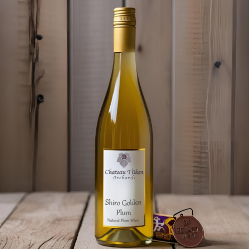 A bottle of sitrio golden plum wine on a wooden table