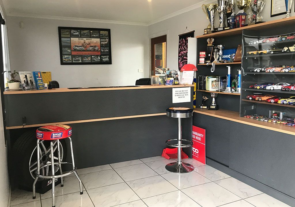 A Room With A Counter And Stools And Trophies On The Shelves  — Coffs Harbour Automotive In Coffs Harbour, NSW