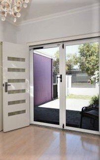 Living Room with a Sliding Glass Door Leading to a Patio - Penrith, NSW - ClearShield-Penrith