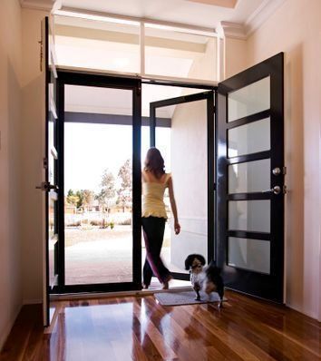 A Woman and a Dog Standing in Front of a Door - Penrith, NSW - ClearShield-Penrith