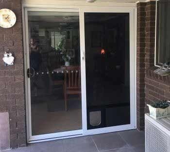 A Sliding Glass Door with a Cat Door in a House - Penrith, NSW - ClearShield-Penrith